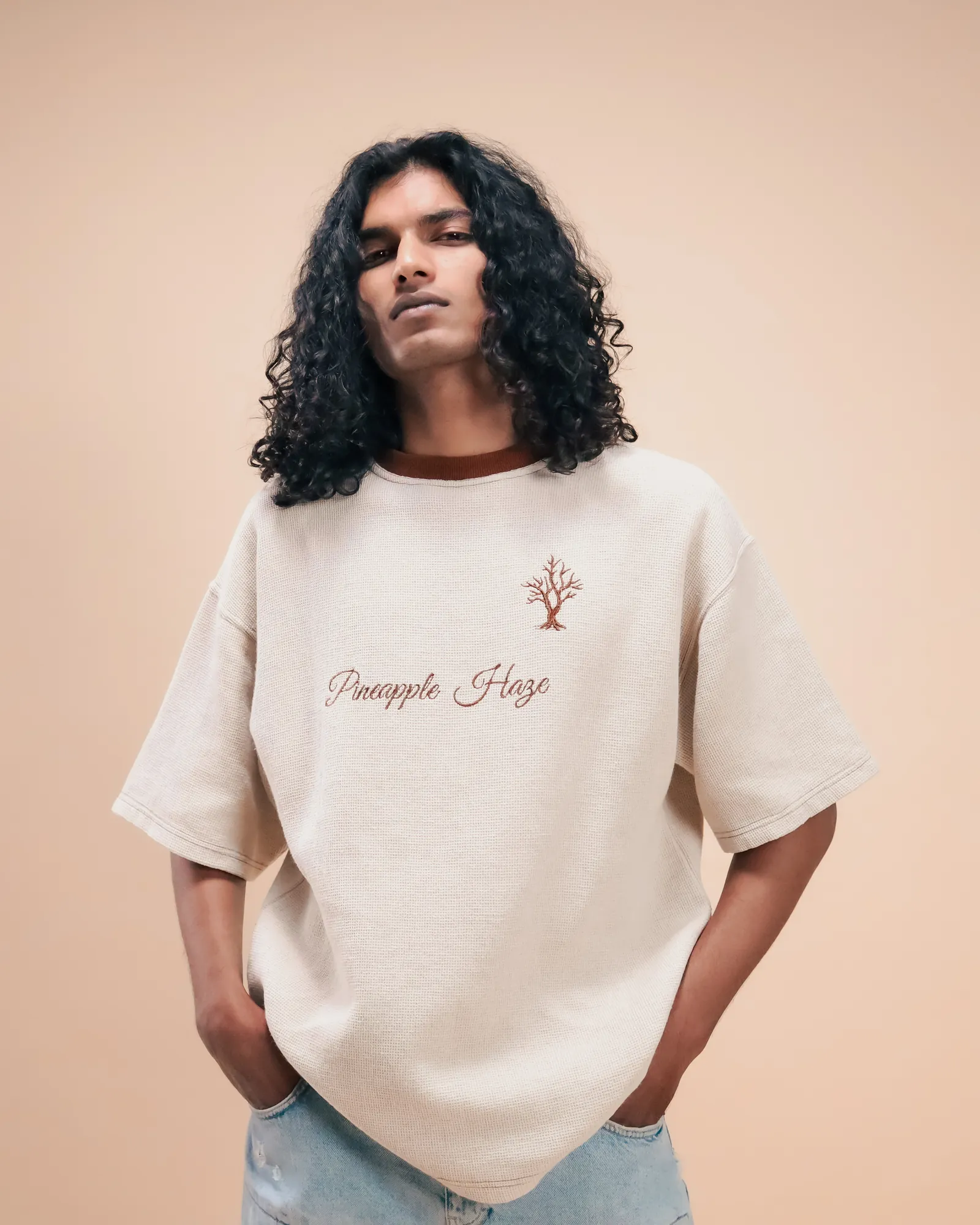 The Pineapple Haze tee worn from the front: the tree and the script embroidered on the chest