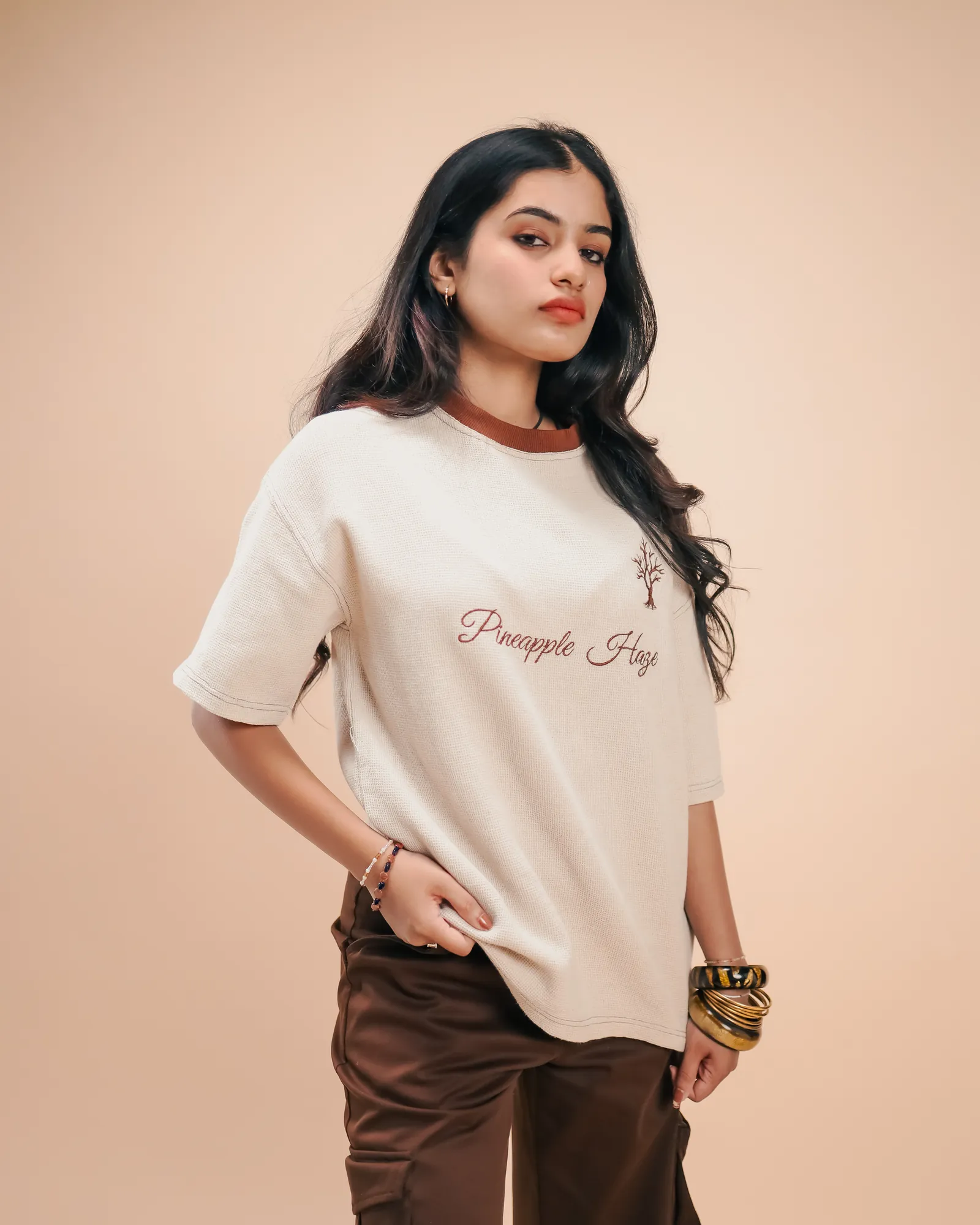 The Pineapple Haze tee worn loose over brown cargo trousers